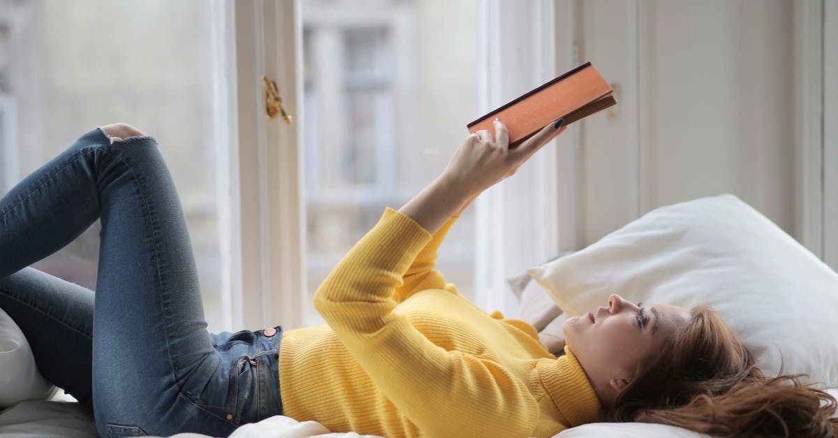 Is it possible to go back to the Slums after story finished? - Young peaceful woman reading book on bed Is it possible to go back to the Slums after story finished? - Young peaceful woman reading book on bed