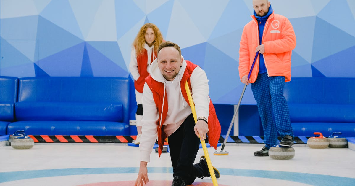 Is it possible to have a strong scout? - Cheerful sportsman playing in curling in ice rink Is it possible to have a strong scout? - Cheerful sportsman playing in curling in ice rink