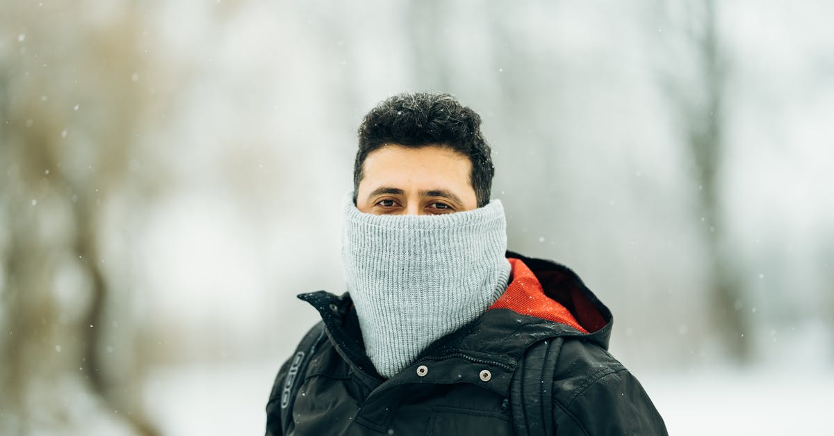 Is it possible to hide your backpack or helmet? - Man in warm outerwear in winter park Is it possible to hide your backpack or helmet? - Man in warm outerwear in winter park