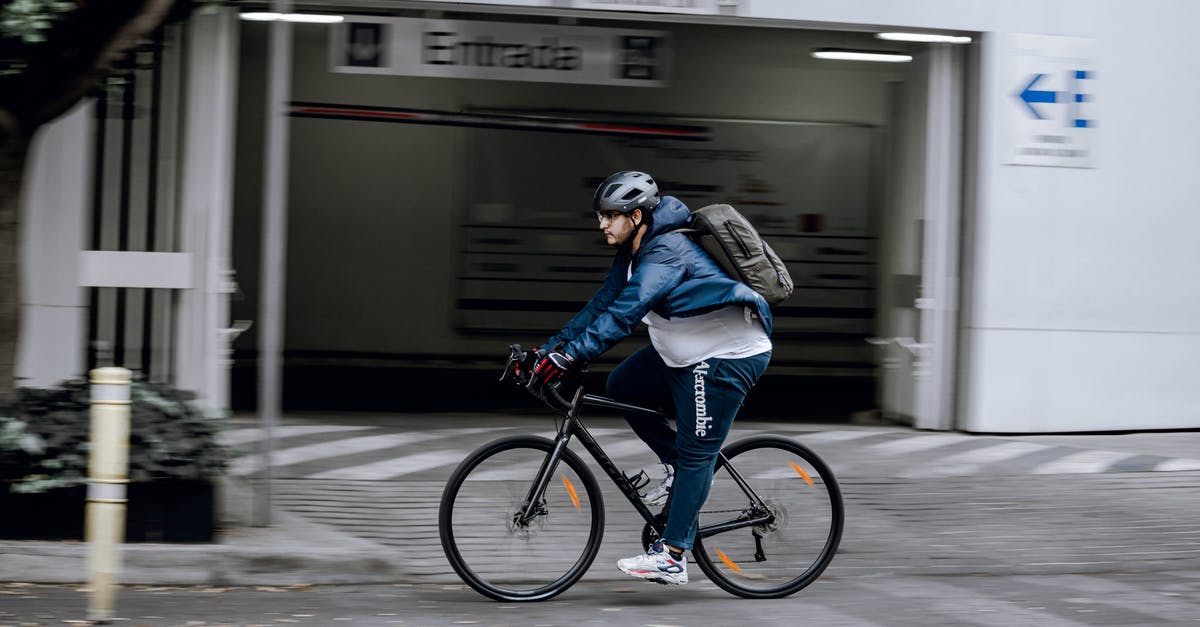 Is it possible to hide your backpack or helmet? - Man in Blue Jacket Riding on Black Bicycle Is it possible to hide your backpack or helmet? - Man in Blue Jacket Riding on Black Bicycle