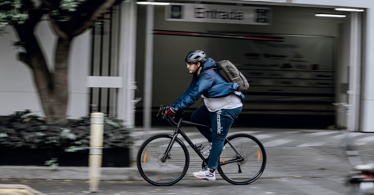 Is it possible to hide your backpack or helmet? - Man in Black Jacket Riding on Black Bicycle Is it possible to hide your backpack or helmet? - Man in Black Jacket Riding on Black Bicycle