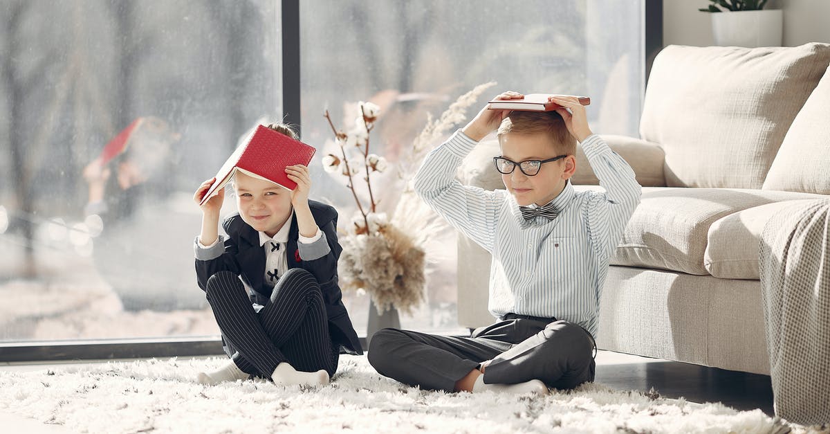 Is it possible to multiplayer Project Zomboid with only one copy of the game? - Full body happy little students in uniform and eyeglasses sitting on floor near sofa and window putting books on head while staying in modern room