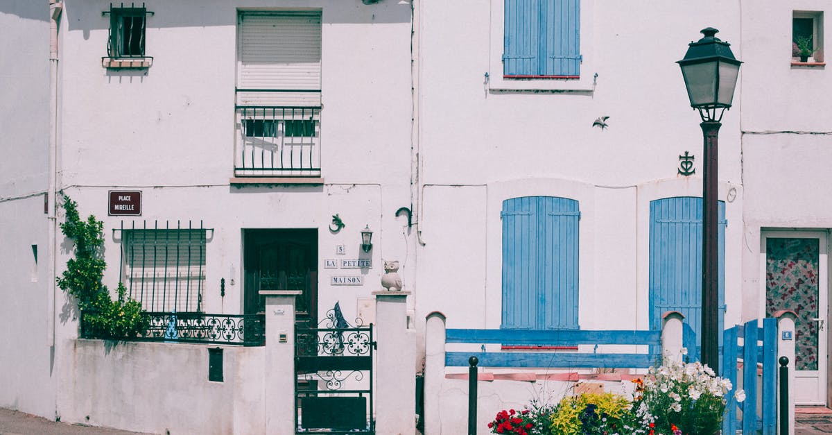 Is it possible to place doors in existing structures? - Classic cement house on city street Is it possible to place doors in existing structures? - Classic cement house on city street