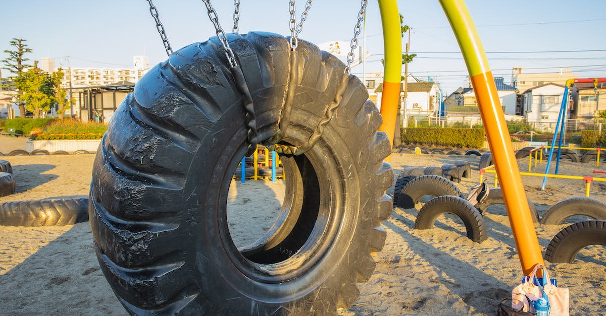 Is it possible to play new Skyrim DLC using an old character? - Swing made of huge rubber tyre for kids located on playground in suburb yard