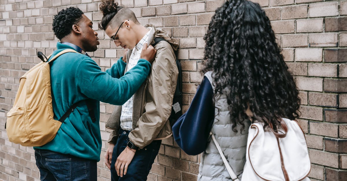 Is it possible to push enemies off ledges? - Multiracial students having argument on street Is it possible to push enemies off ledges? - Multiracial students having argument on street