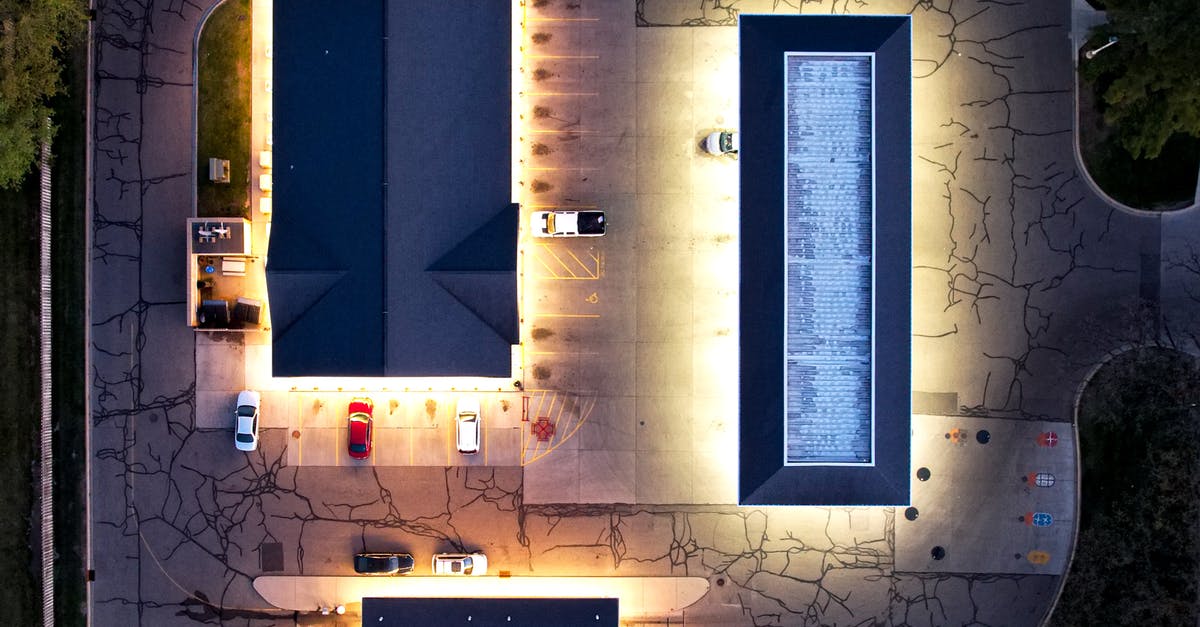 Is it possible to reach the Claptrap above Marcus's store in Fyrestone? - Bird's Eye View of Illuminated Store Buildings with Parking Space Is it possible to reach the Claptrap above Marcus's store in Fyrestone? - Bird's Eye View of Illuminated Store Buildings with Parking Space