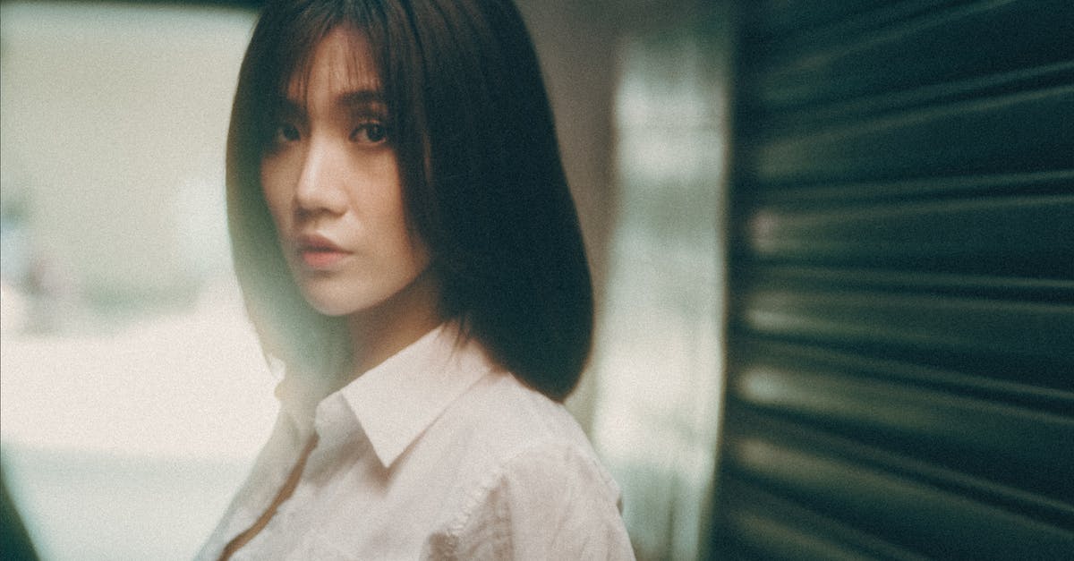 Is it possible to reset your character and town name? - Young ethnic female in white blouse looking at camera while resting on city street Is it possible to reset your character and town name? - Young ethnic female in white blouse looking at camera while resting on city street