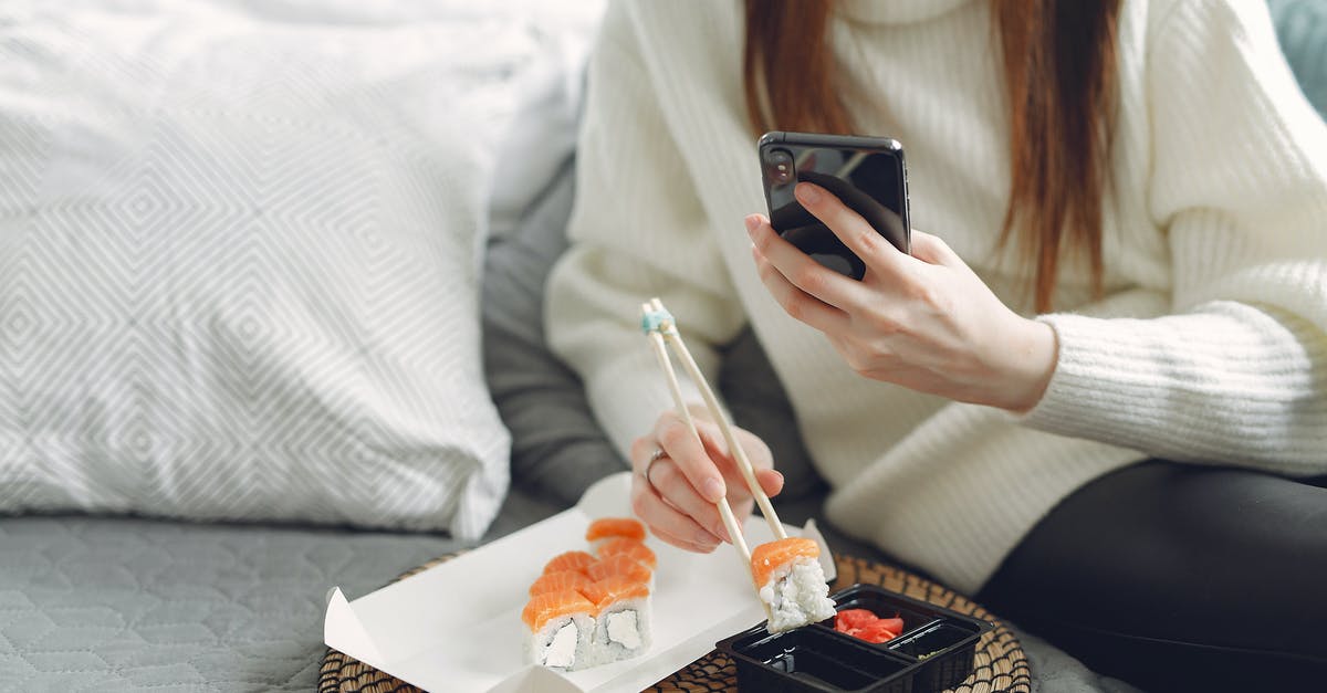 Is it possible to roll using the controller? - From above of unrecognizable woman in knitted sweater eating sushi with chopsticks and taking photo for social media while sitting on comfortable sofa in modern apartment Is it possible to roll using the controller? - From above of unrecognizable woman in knitted sweater eating sushi with chopsticks and taking photo for social media while sitting on comfortable sofa in modern apartment