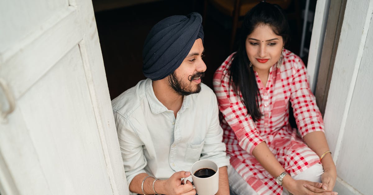 Is it possible to tell if the Gangsters will backstab you on Day 2 of rats? - From above of good looking Indian wife listening to husband sharing news with cup of coffee in hand while both sitting at doorstep of house