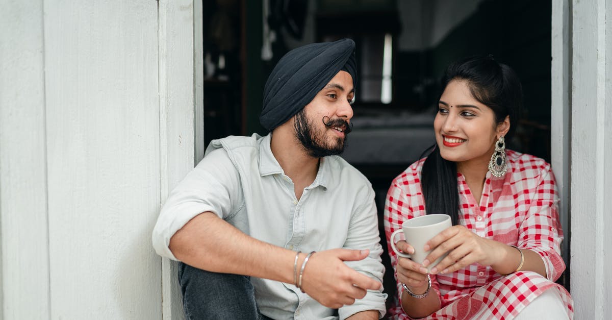 Is it possible to tell the duration of someone else's lure? - Positive Indian spouses in casual outfits sharing interesting stories while drinking morning coffee on doorstep of house
