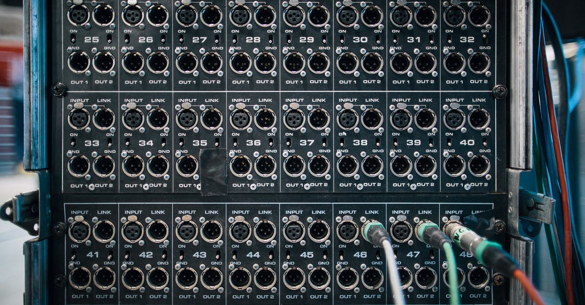 Is it safe to use an unofficial cable to power a console? - Assorted wires with connectors in sockets of sound reinforcement system with numbers in row on stage