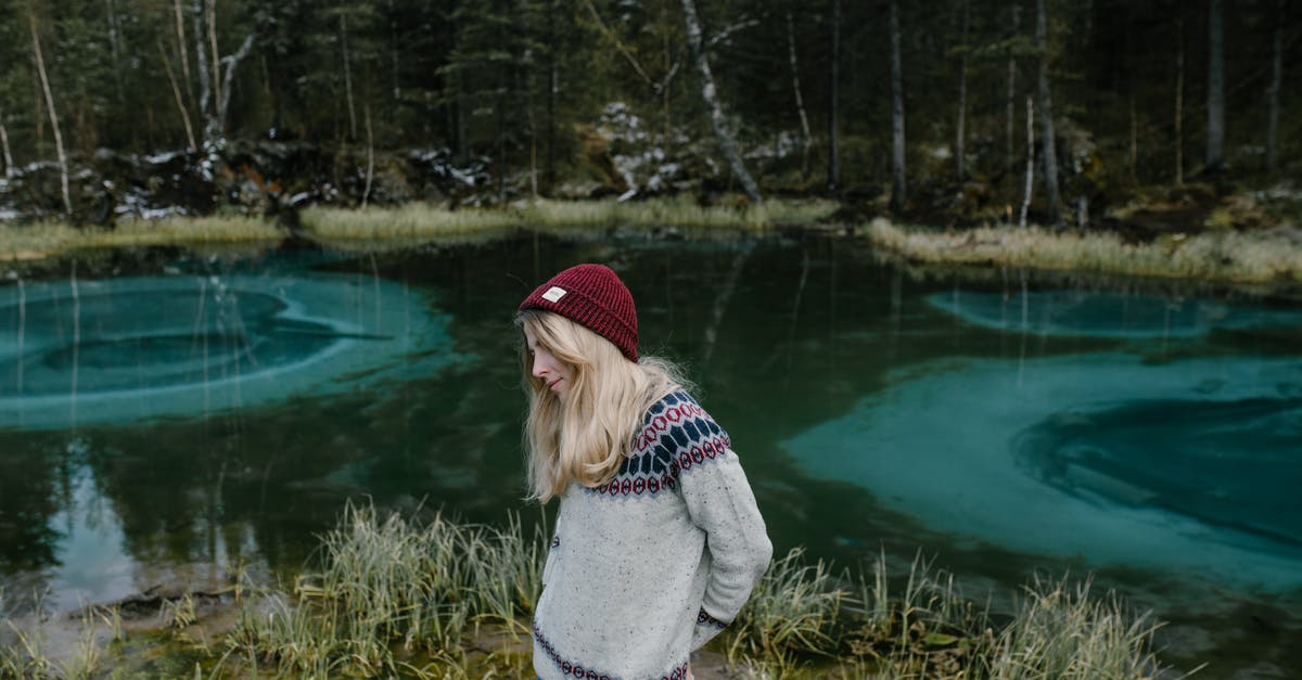 Is it still possible to get hat drops - Female on bank of lake with blue water