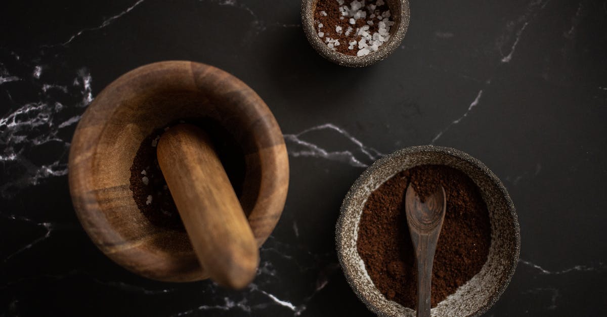 Is it viable to grind above Normal for Torment now? - High angle of wooden mortar and pestle placed near ceramic bowl with aromatic coffee on black marble table