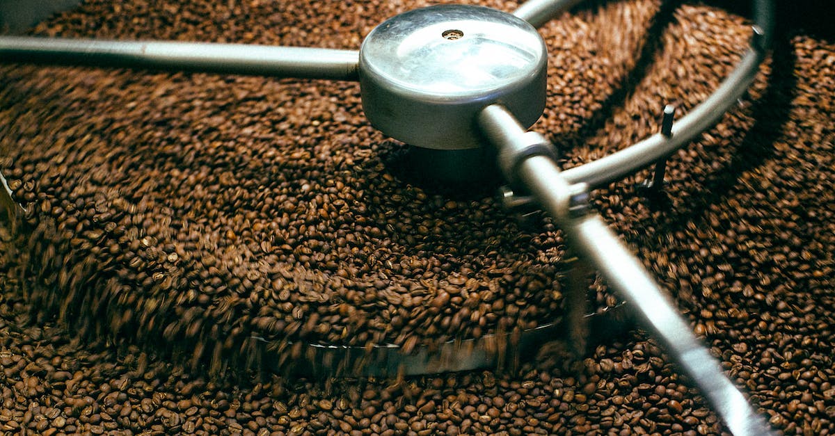 Is it viable to grind above Normal for Torment now? - From above of fresh aromatic brown coffee beans mixing in professional roasting machine