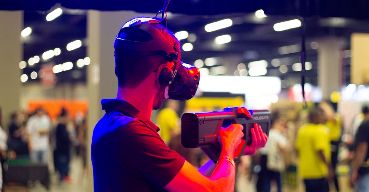 Is Minecraft VR cross play with other platforms? - Back view of young male in casual clothes and VR headset standing in spacious hall while testing device operation Is Minecraft VR cross play with other platforms? - Back view of young male in casual clothes and VR headset standing in spacious hall while testing device operation