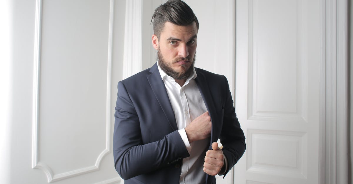 Is my job successful if I die after the objectives are complete? - Man in Blue Suit Standing Beside White Wooden Wall