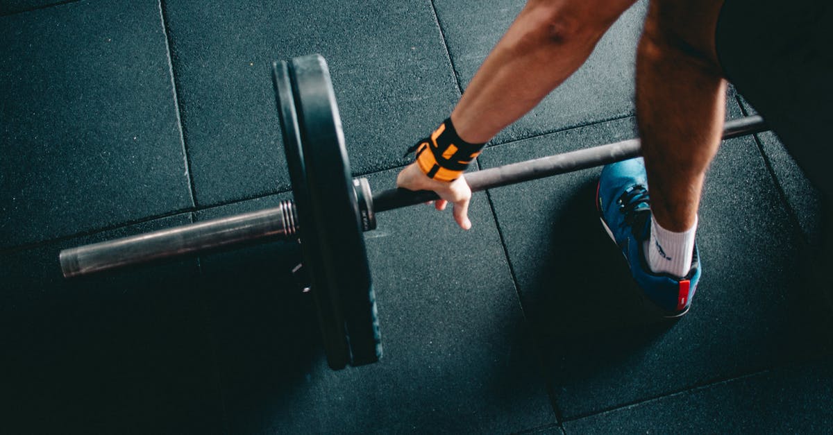 Is Orc or Imperial better for a one-handed heavy armor warrior? - Person Wearing Black Shorts and Blue Lace-up Low-top Sneaker Holding Black Barbell