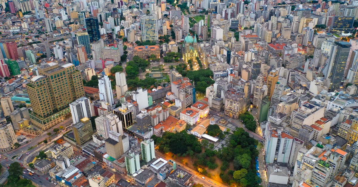 Is placing parks in Industrial area a good idea? - Aerial view of contemporary city residential district with towers near green parks and roads