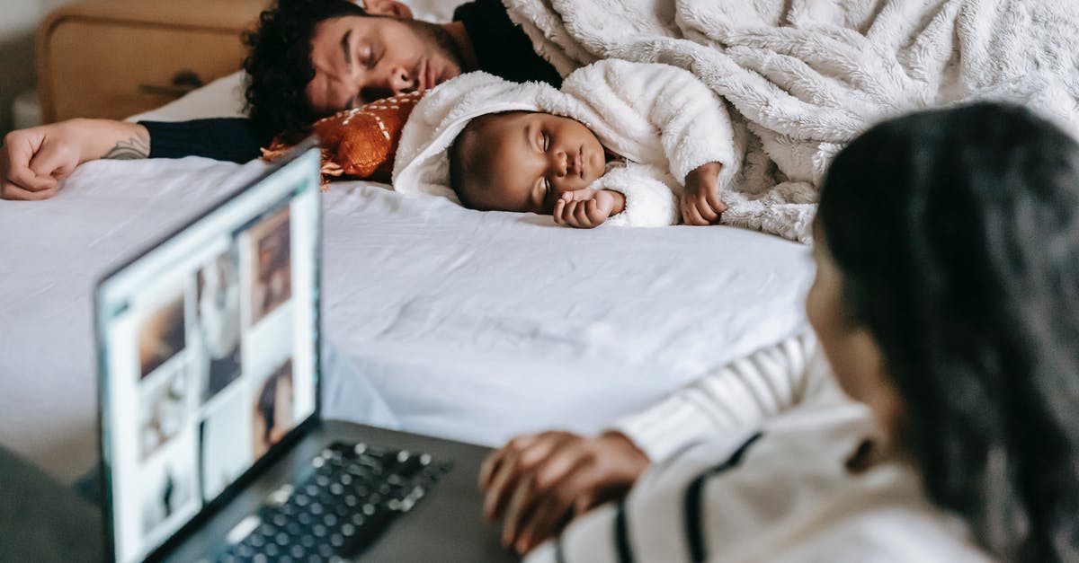 Is Quiet connected? - Anonymous ethnic mother working on netbook near baby and husband sleeping in bedroom