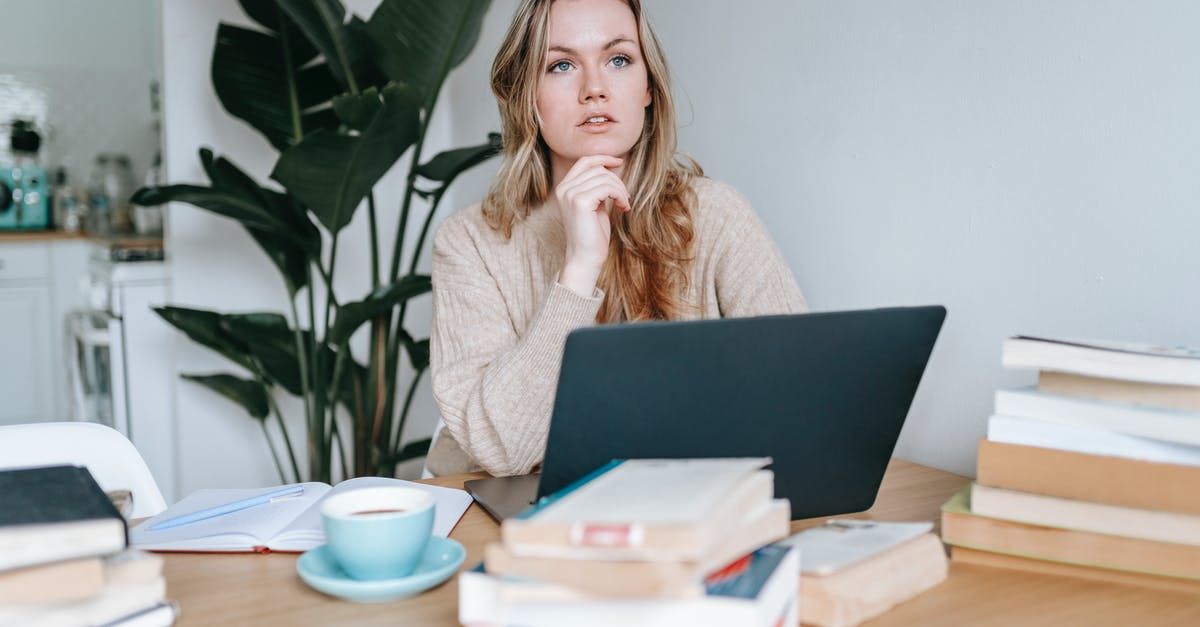 Is Quiet connected? - Focused businesswoman thinking on project at laptop at home Is Quiet connected? - Focused businesswoman thinking on project at laptop at home