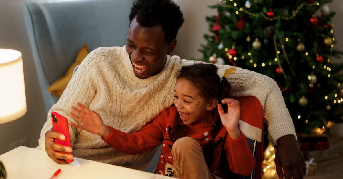 Is "PlayOnLinux's virtual drives" folder necessary? - Dad and Daughter Having Fun and Laughing While Looking at the Smartphone