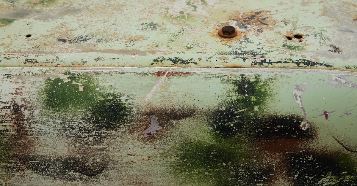 Is scrap metal from non-tradable+tradable still tradable? - From above of aged rusty metal mechanism with scratches and painted with spray paint
