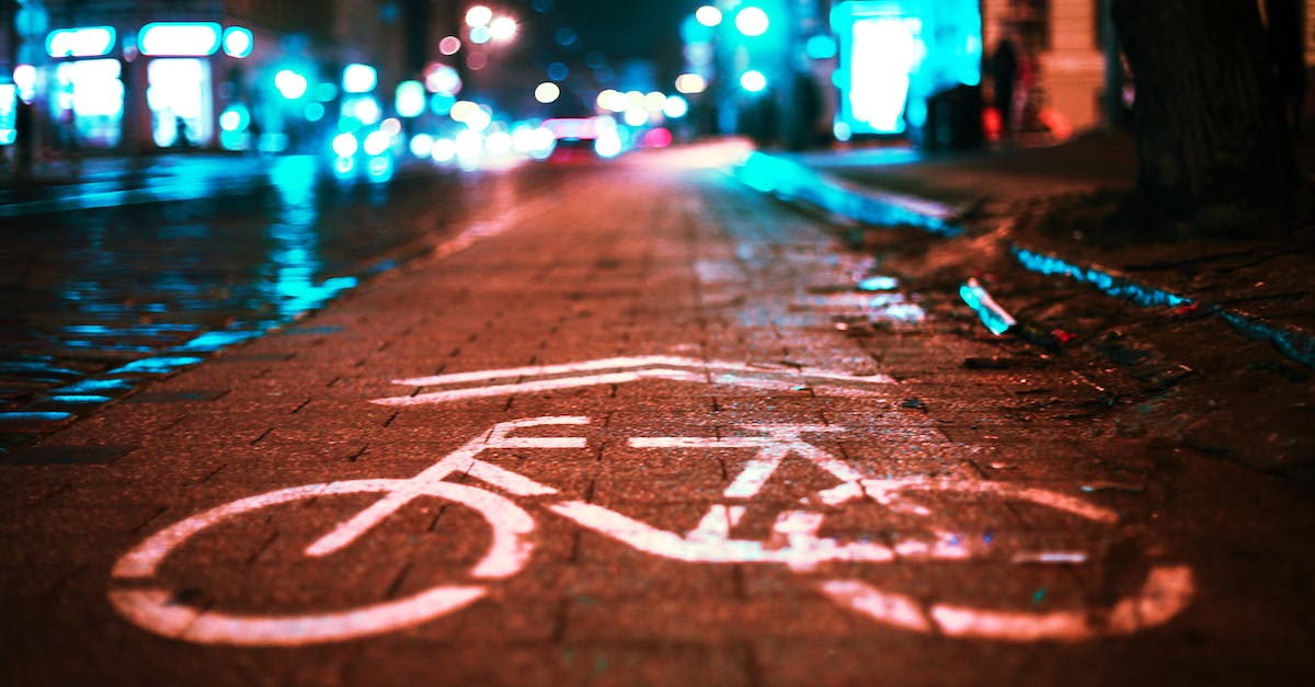 Is the day-night cycle purely cosmetic? - Selective focus of marking for cyclist and blue neon lights of city at night