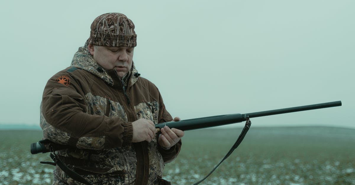 Is the hunting rifle the possibly strongest ballistic weapon? - Photo of Man in Camouflage Jacket Holding a Rifle