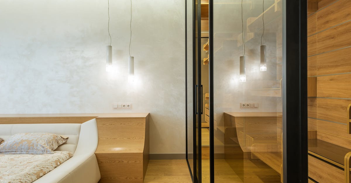 Is the new Feast mastery more impactful than Double Edged Sword? - Modern bedroom with king sized bed and walk in wardrobe closet with glass doors and walls in beige and white colors lighted with led lamps