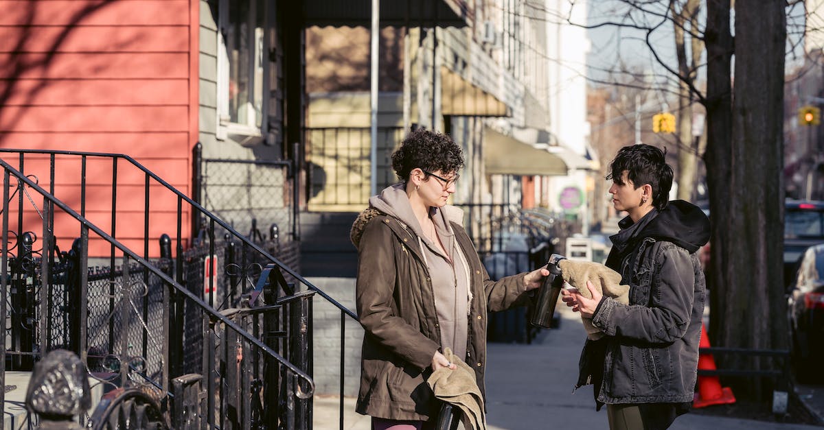Is the season pass shared between PSN accounts? - Adult sportswomen in activewear and warm clothes sharing towels and water bottles while standing on sunny autumn street