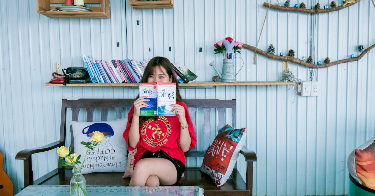 Is the selected Clan War Base unusable if it as the little red house icon? - Woman in Red Shirt Holding Book Sitting on Bench in Front of Coffee Table
