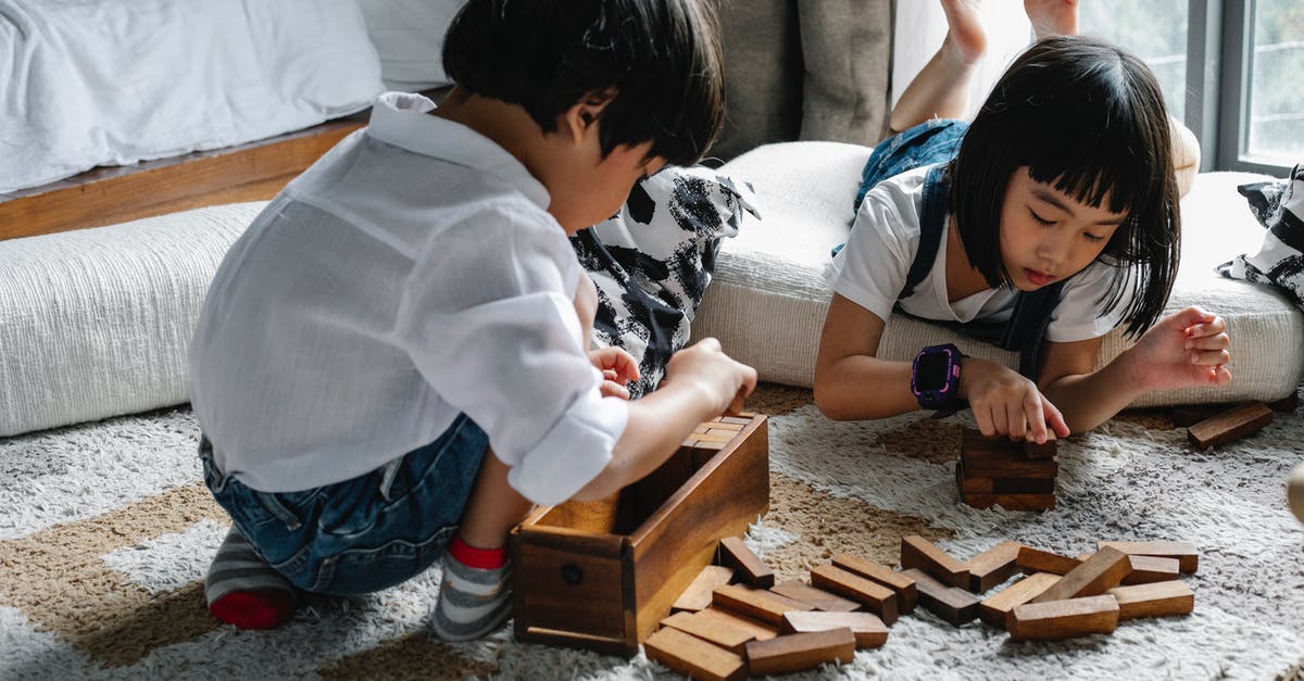 Is the tower game shown in the 'Hero Wars' ad a real game? - Asian kids playing with wooden blocks