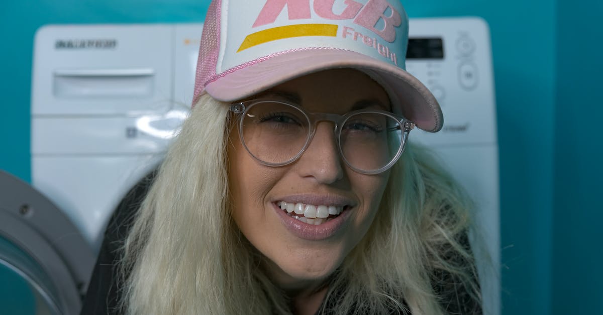 Is the will cap in XCOM 150? - Woman in Pink White and Blue Fitted Cap and Black Framed Eyeglasses