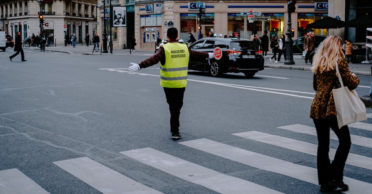 Is there a cheat to disable police wanted levels? - Man in Green Vest Guiding a Woman Crossing the Street on Pedestrian Lane Is there a cheat to disable police wanted levels? - Man in Green Vest Guiding a Woman Crossing the Street on Pedestrian Lane