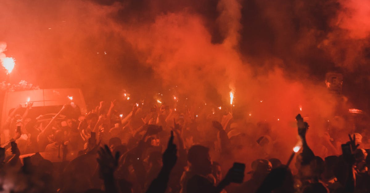 Is there a difference between a fire team and a regular team? - Expressive fans celebrating victory on street at night