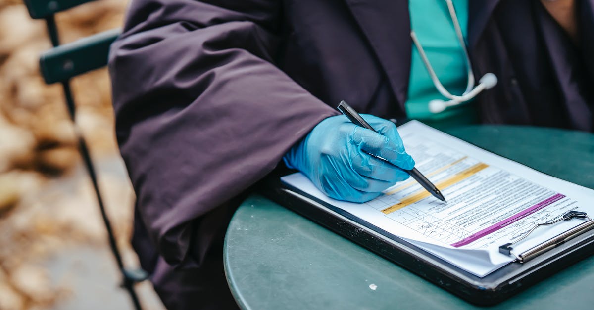 Is there a Doctor anywhere on Point Lookout? - Crop anonymous female doctor in uniform with stethoscope pointing with pen at text on paper during work