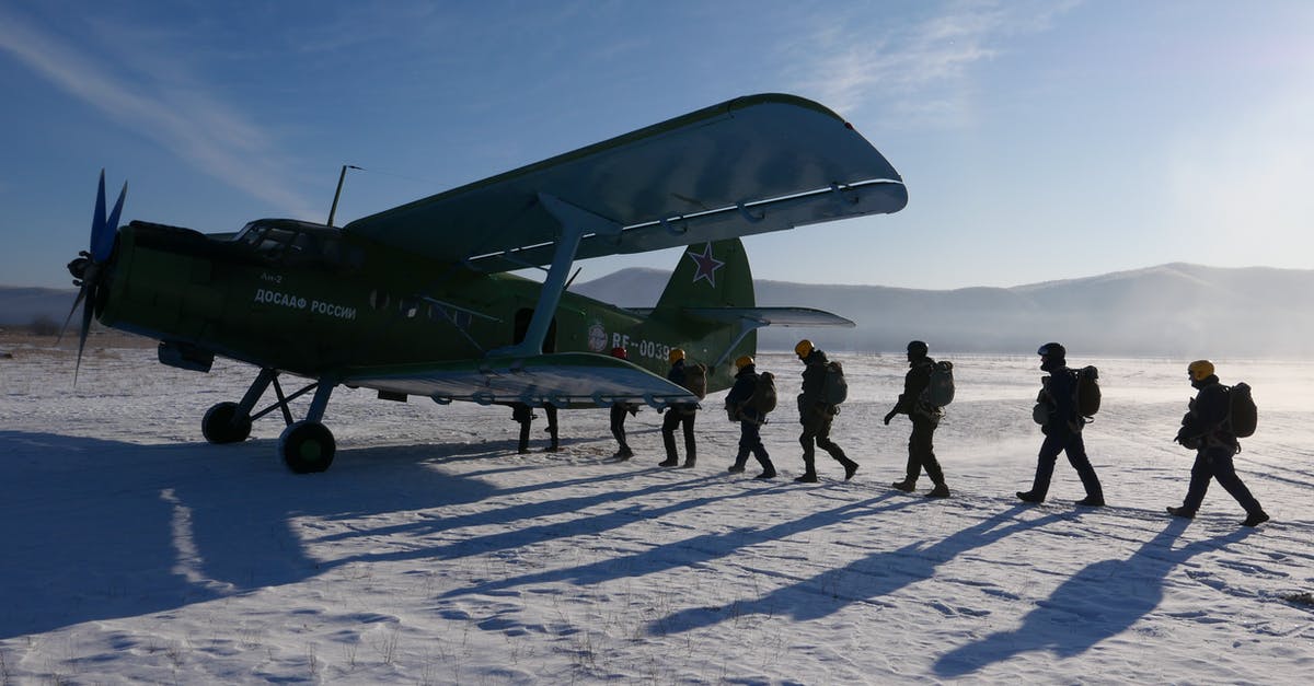 Is there a downside to killing civilians outside of retaliation missions? - Group of military men in uniform loading into aircraft during test operation in snowy ground of airfield on sunny cold winter day