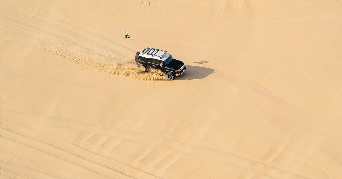 Is there a fast way to return to the ground level on Tiny Tower? - From above of modern black car driving in desert with sandy ground in daytime Is there a fast way to return to the ground level on Tiny Tower? - From above of modern black car driving in desert with sandy ground in daytime