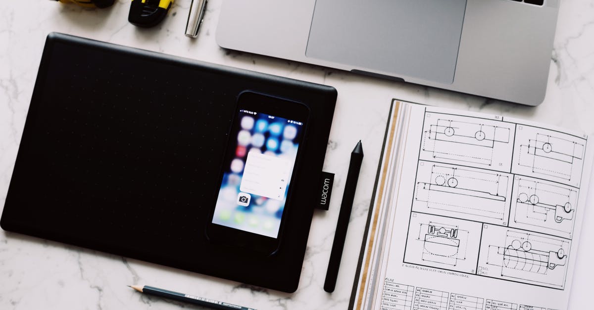 Is there a fix for the white screen when opening the PokéStore? - From above view of modern workplace with laptop and tablet and smartphone placed near opened notebook with drawings and pen with pencil on white marble table