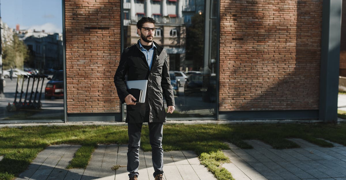 Is there a limit for the waiting queue outside the vault? - Man in Black Jacket Standing Beside a Brick Building Is there a limit for the waiting queue outside the vault? - Man in Black Jacket Standing Beside a Brick Building