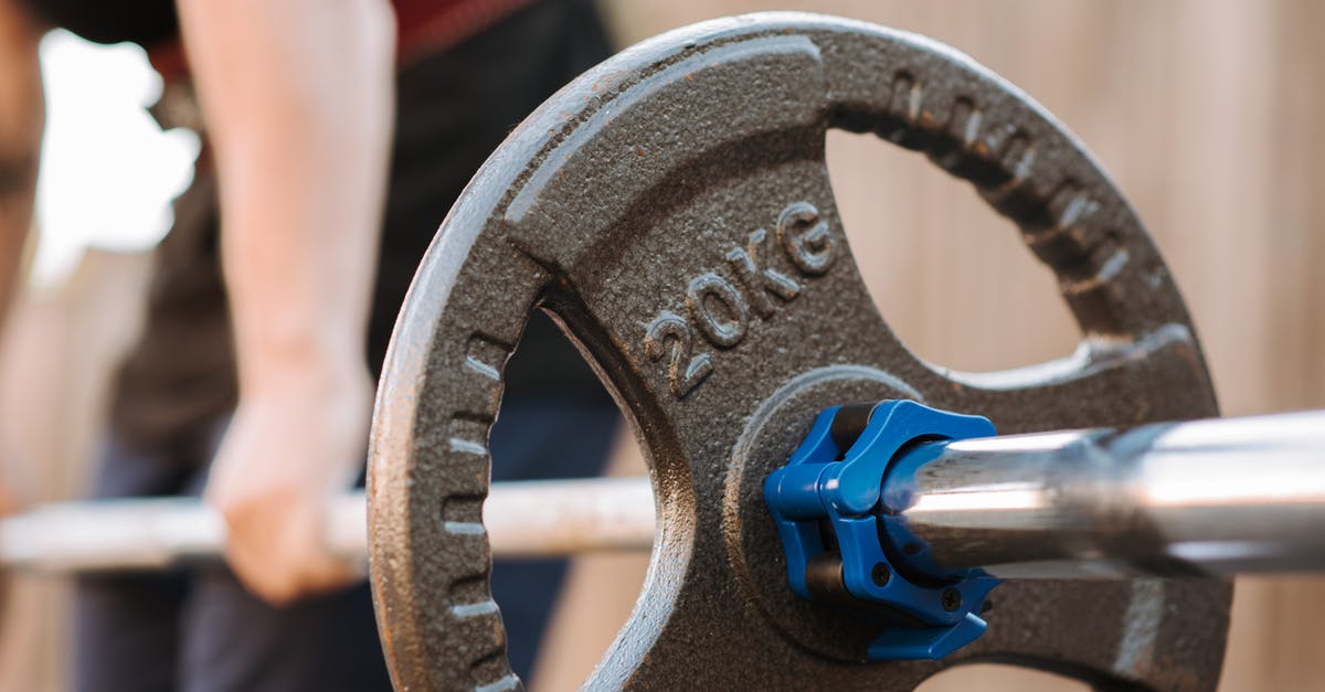 Is there a limit to the number of Power Armor sets you can keep? - Side view of crop anonymous male athlete preparing to lift barbell with stainless steel bar and plastic collar in daylight