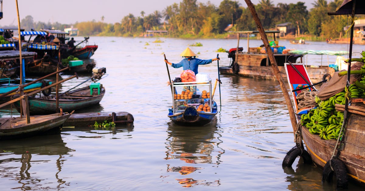 Is there a merchant who sells shipments of wood? - Person Riding on Boat