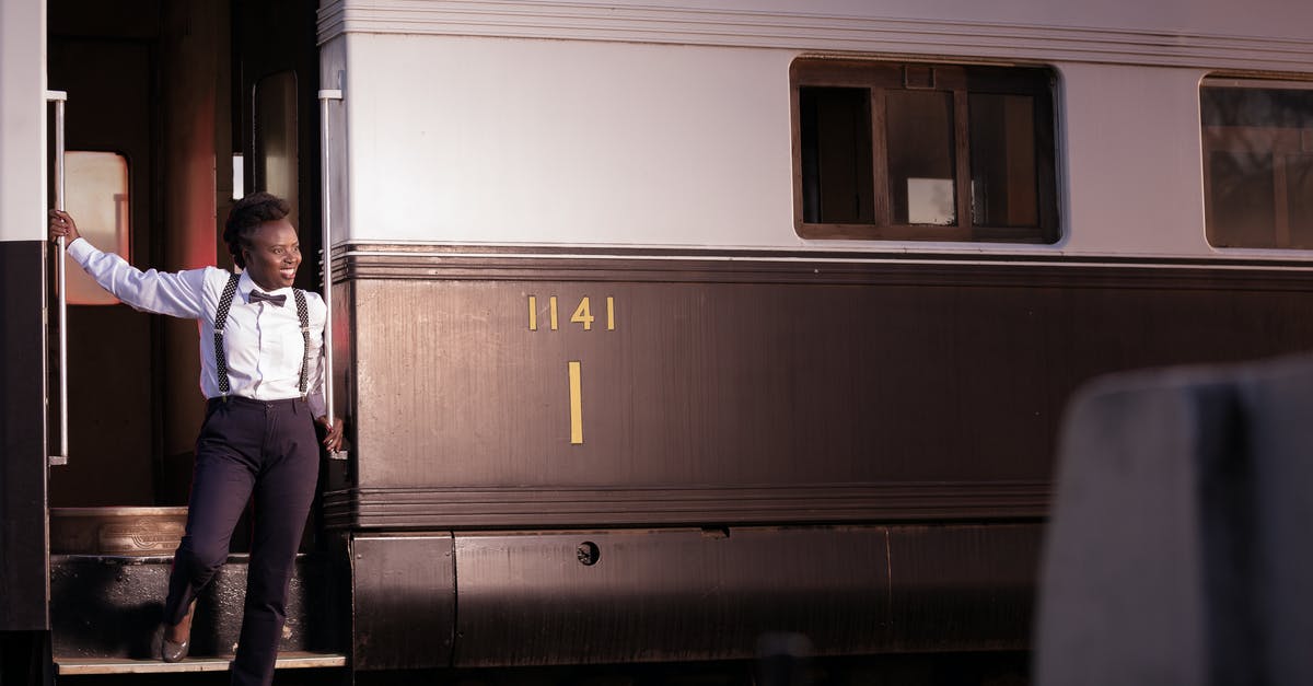 Is there a penalty to interrupting training? [duplicate] - Woman in White Shirt and Black Pants Standing Beside Train