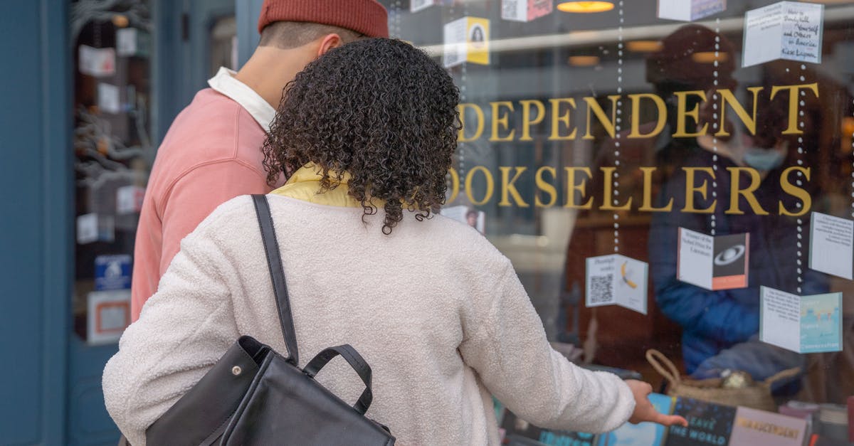 Is there a point to collecting Achievements? - Anonymous couple hugging while standing on street near bookshop window