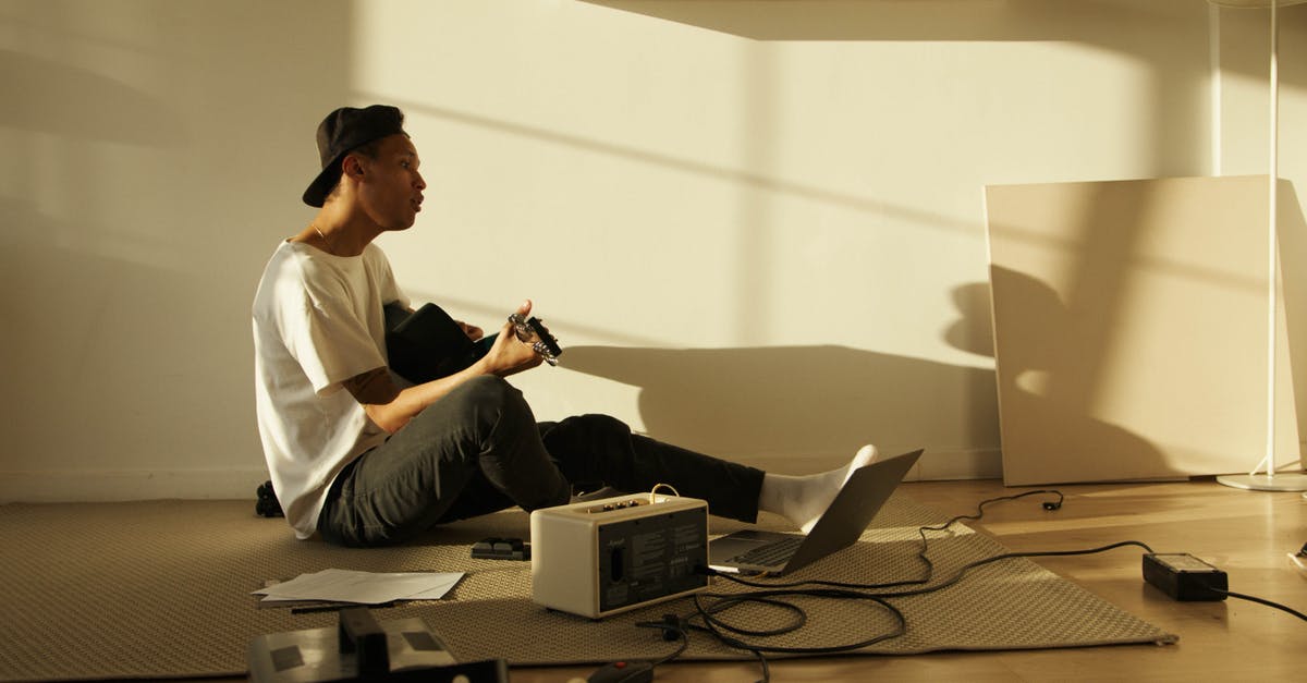 Is there a purpose to the room in the back of the inn? - Man in White Button Up Shirt and Black Pants Sitting on Brown Sofa Is there a purpose to the room in the back of the inn? - Man in White Button Up Shirt and Black Pants Sitting on Brown Sofa