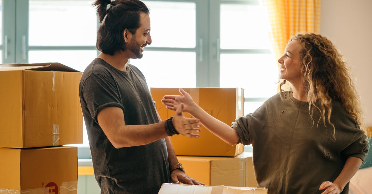 Is there a quicker way for me to give items to other characters? - Happy diverse couple among carton boxes in new home Is there a quicker way for me to give items to other characters? - Happy diverse couple among carton boxes in new home