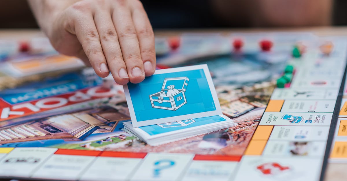 Is there a reason to picking up objects? - Person Picking Monopoly Cards