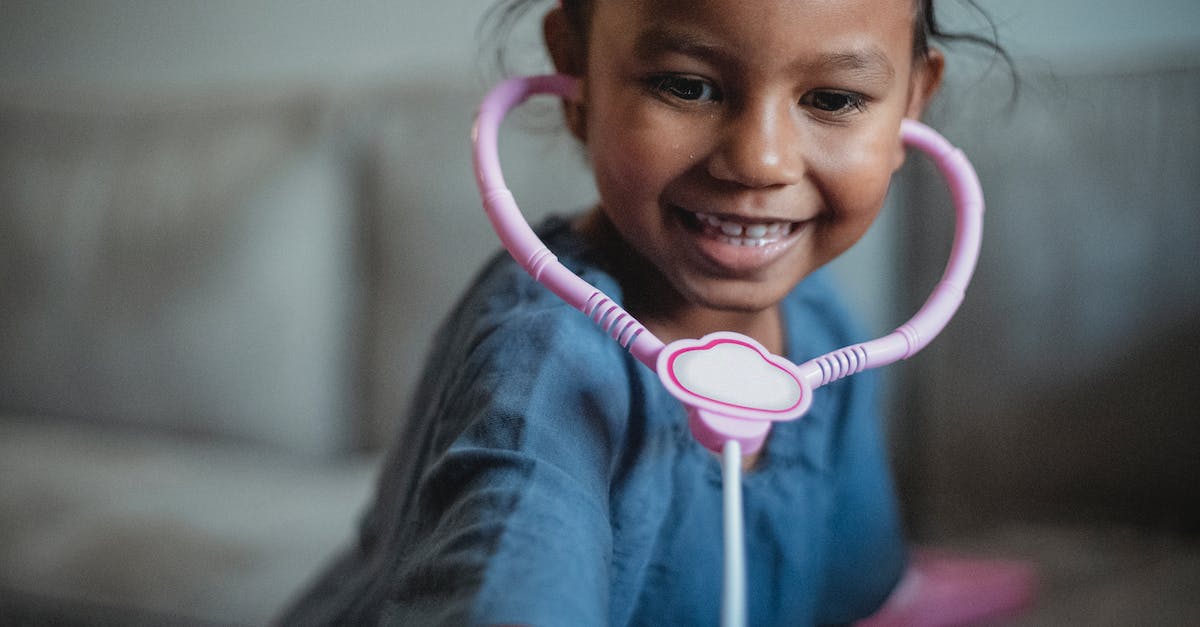 Is there a risk of inbred children with fake fatherhood? - Delighted little ethnic kid with fake stethoscope leaning forward while playing doctor near couch on blurred background in living room