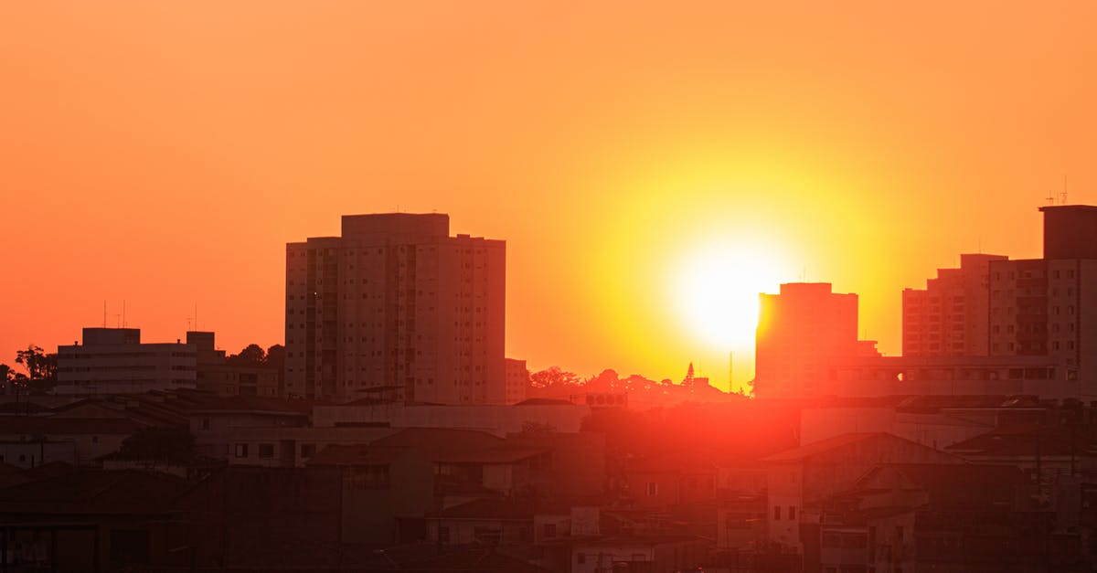 Is there a setting for slowly killing units that are outside a city or military base? - Bright sunset sky over city