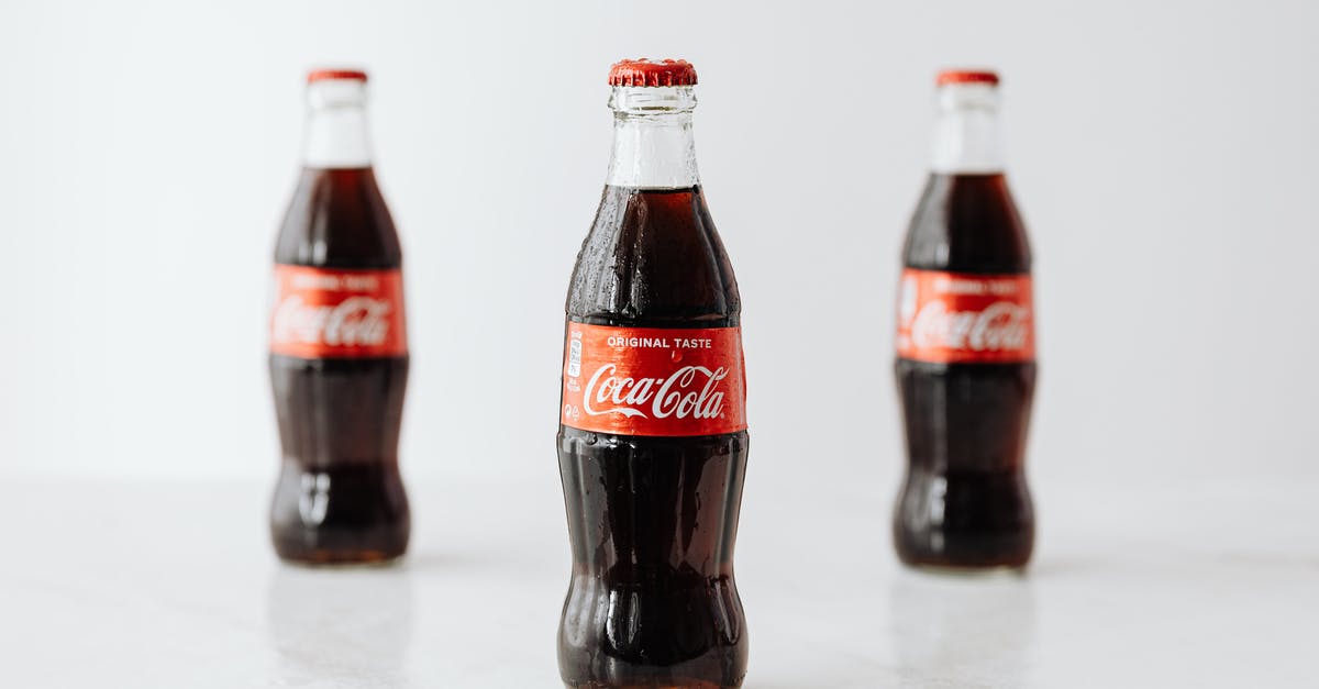 Is there a simple way to identify the true Lunatic Cultist? - Modern glass bottles of cold soda with red label placed on white reflective surface Is there a simple way to identify the true Lunatic Cultist? - Modern glass bottles of cold soda with red label placed on white reflective surface
